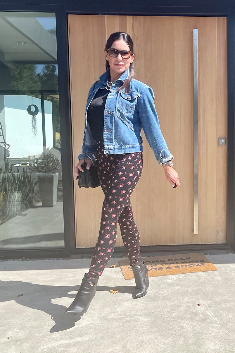 Kat Woodside, Chief Design Officer models her outfit of the day featuring the Complete Top in Black and the Printed Lean Legging in Flower Burst.