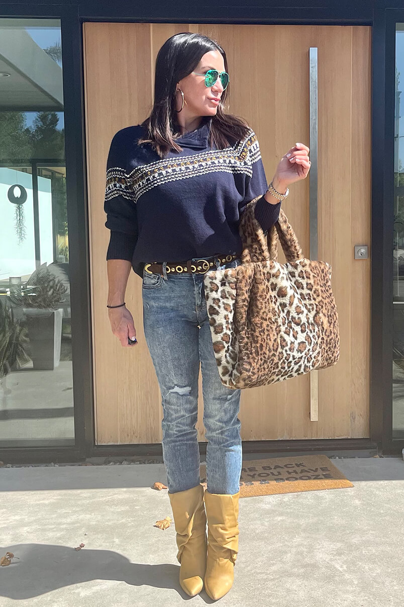 Kat Woodside, Chief Design Officer models her outfit of the day featuring the Cinch Skinny in Adventure Wash, Fair Isle Pullover in Dark Sapphire, and and statement accessories.