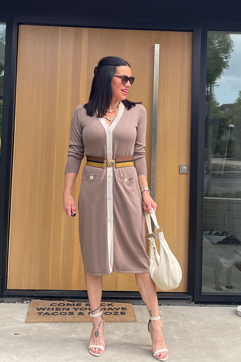 Kat Woodside, Chief Design Officer models her outfit of the day featuring the Genteel Cardigan in Taupe, statement accessories and stilettos.